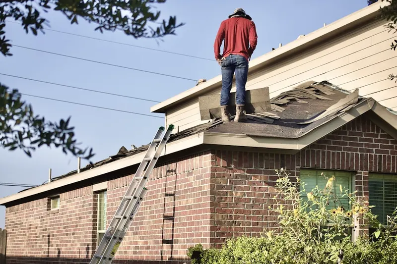 Professional roofer working on a residential roof in Merrimac